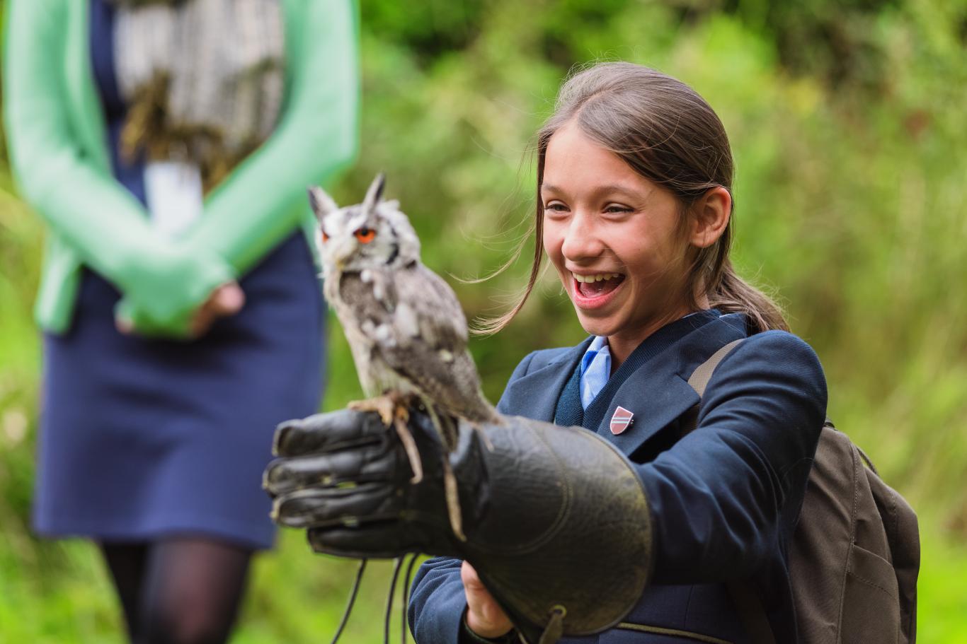 A CLC Biology student holding an owl