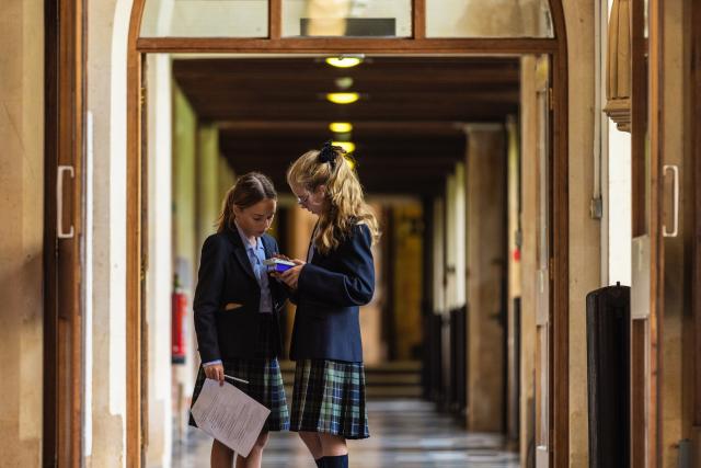 Two Year 7 pupils take part in a scavenger hunt in the Marble Corridor at CLC