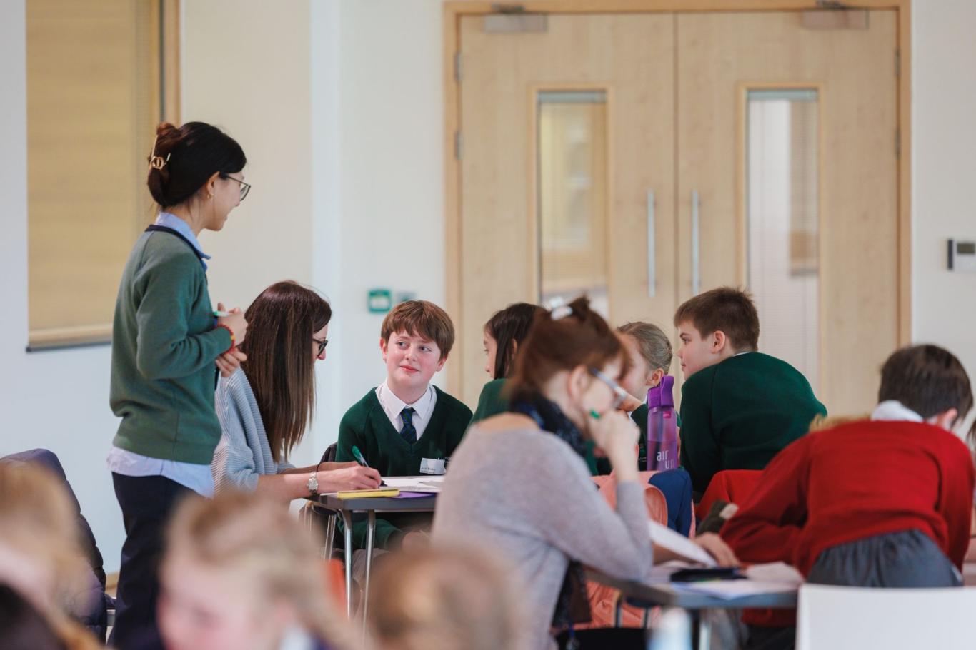 CLC student volunteering at a Year 5 Maths Challenge Event hosted by the school.
