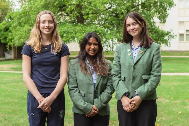 Year 13 Scholars, Anna, Azra and Lily standing in the CLC gardens