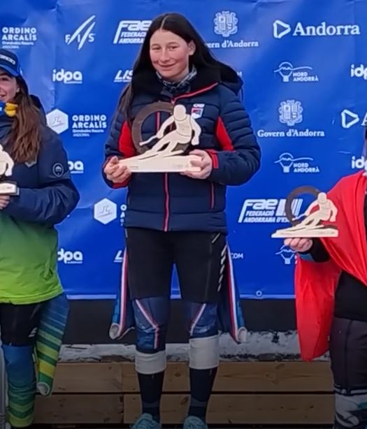 Year 8 student Alice holding her medal on the podium