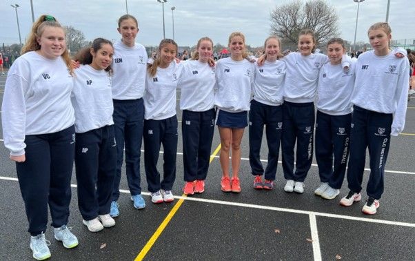 10 CLC netball players wearing their kit on the outdoor netball court