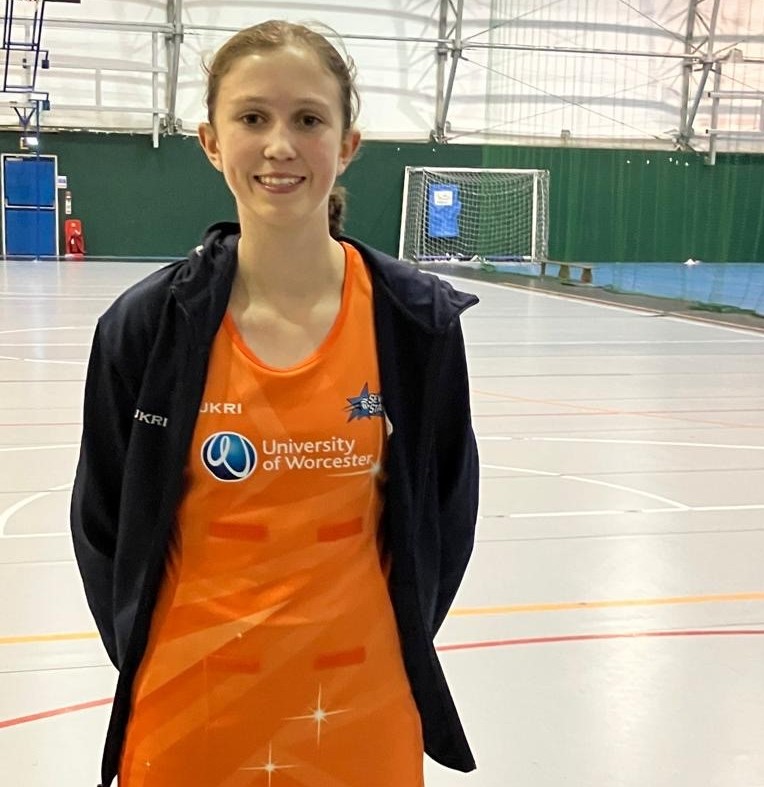 Year 9 student Ella dressed in netball kit at a netball court